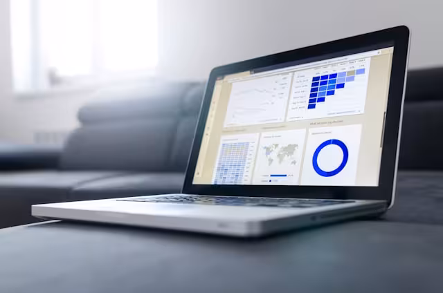 A laptop screen displaying colorful charts and graphs